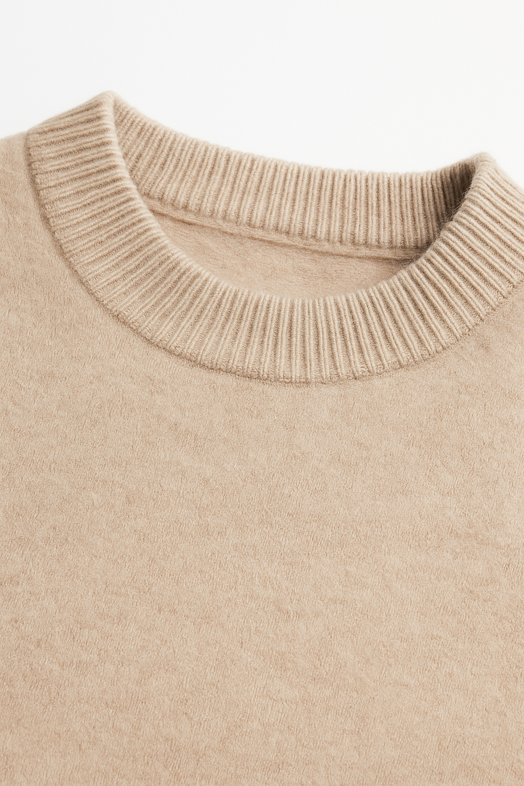 Beige cashmere knit sweater by Emiral Couture, featuring a cozy design and soft texture, perfect for layering.
