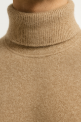 Dark beige Emiral Couture cashmere turtleneck sweater with a soft, luxurious texture and classic design.