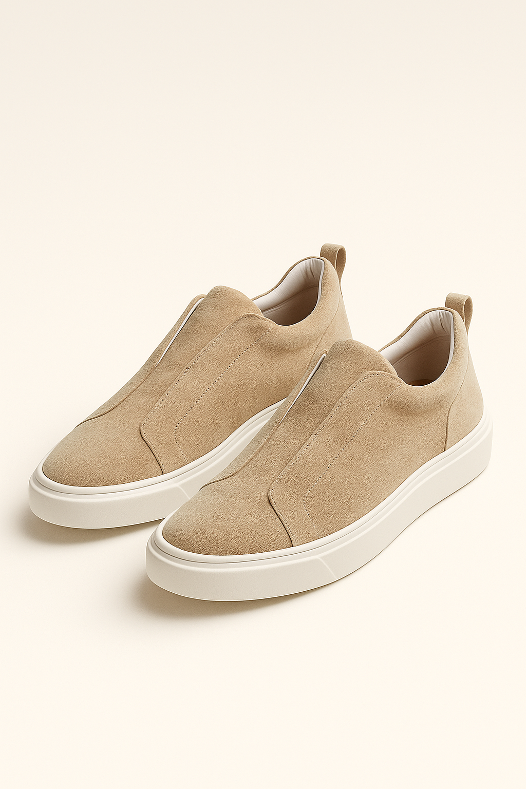 Beige suede slip-on sneakers by Emiral Couture with a sleek design and comfortable fit.
