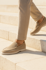 Beige suede loafers by Emiral Couture with a sleek design and comfortable fit, perfect for casual or smart outfits.