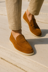 Terracotta Emiral Couture suede loafers displayed on a terrace, featuring a sleek design and comfortable fit.